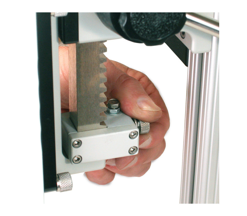 Optional adjustable upper and lower travel stops may be positioned along the length of the rack.