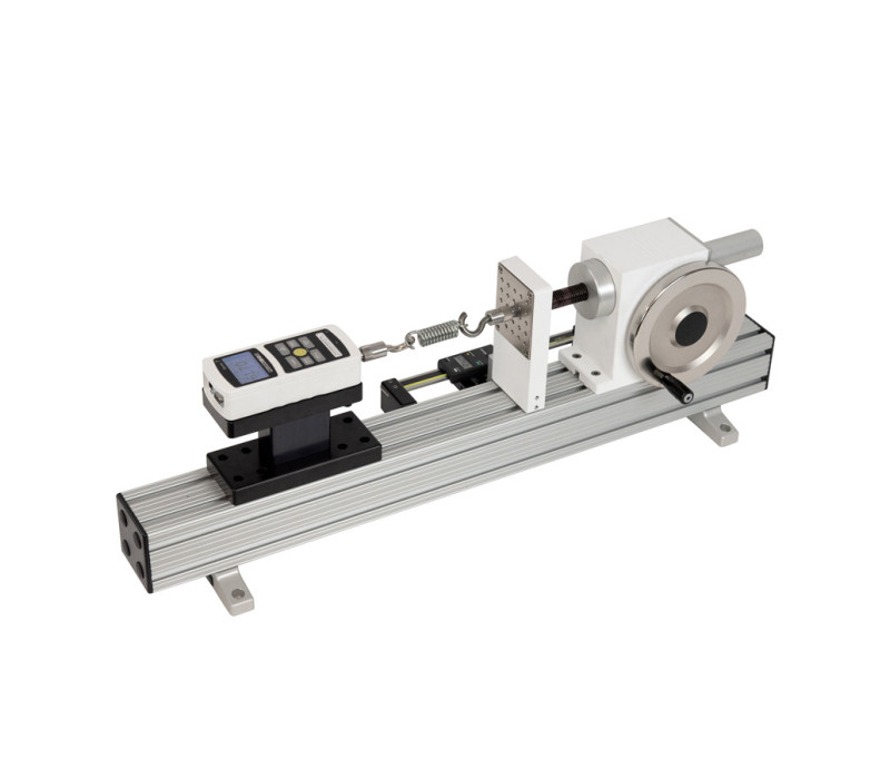 The TSFH horizontal test stand is shown in a tensile testing application with a Model M5-1000 digital force gauge, pair of G1061 wedge grips, and optional digital travel display.