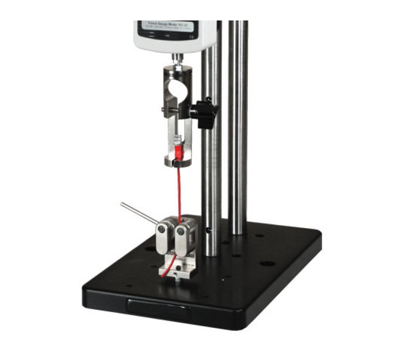 G1001 shown in a typical wire terminal pull testing application, used in conjunction with a digital force gauge, test stand, and G1002 dual roller grip.