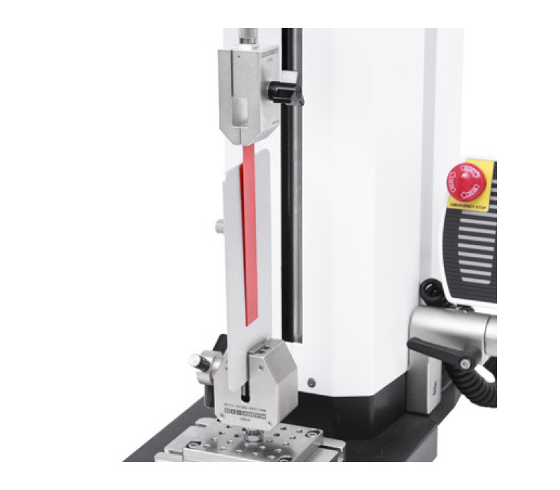 G1008 shown in a 180° peel test of adhesive tape. A metal strip is secured by the G1061 wedge grip.