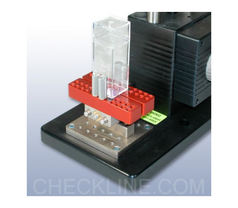 G1058 is shown securing a rectangular container, mounted to a Mark-10 test stand via the G1055 adapter.