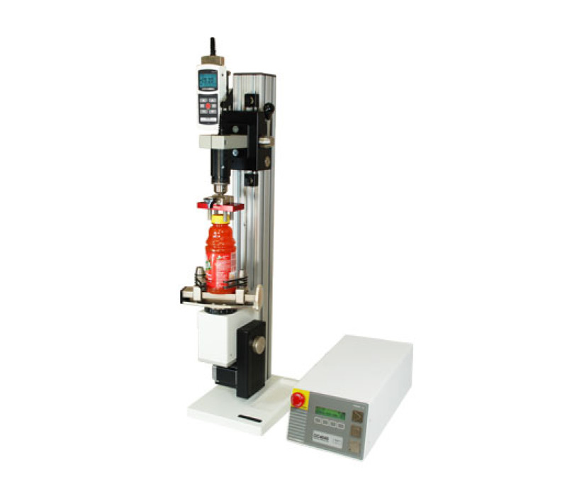 The TSTM-DC vertical advanced motorized torque test stand is shown in a typical bottle cap torque testing application with 5i force/torque indicator, Series R50 torque sensor, and grips.