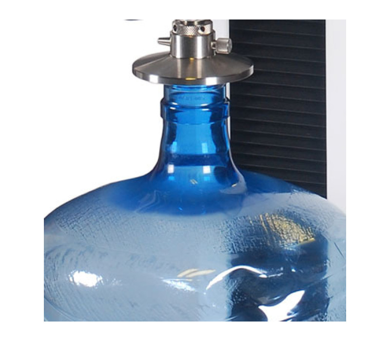 A G1087-1 compression plate is shown in a top load testing application.