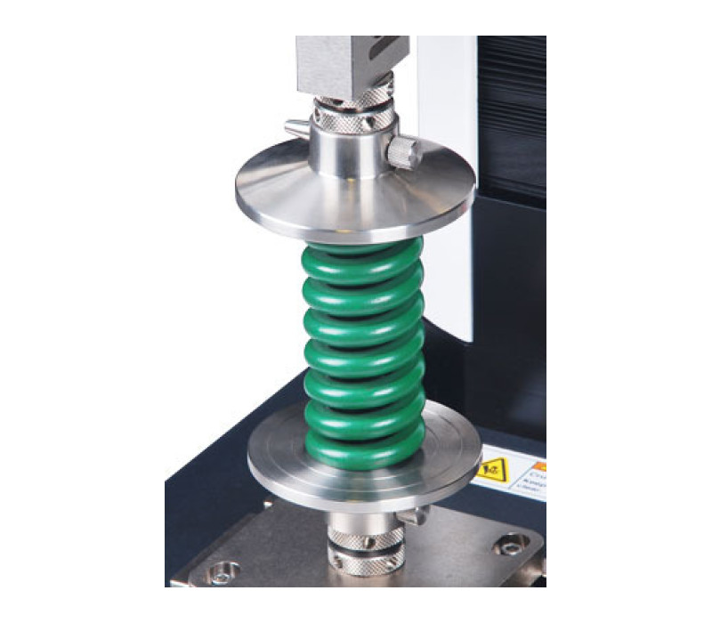 G1087-1 compression plates are shown in a spring testing application.