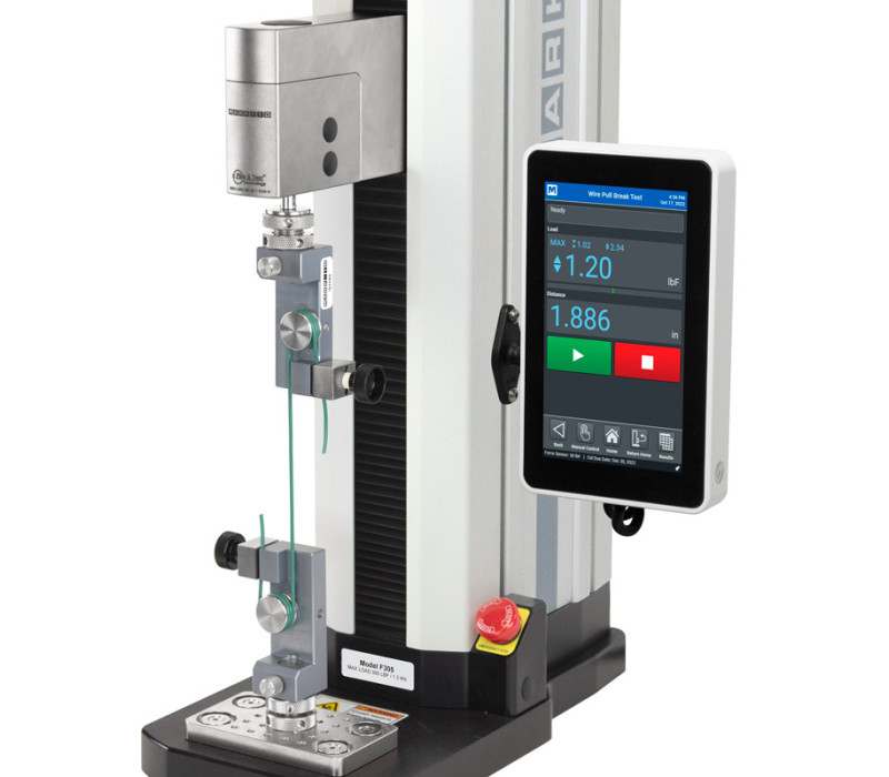 An F305-EM Test Stand is shown configured for a vertical wire pull test with two G1103 Wire / Rope Grips.