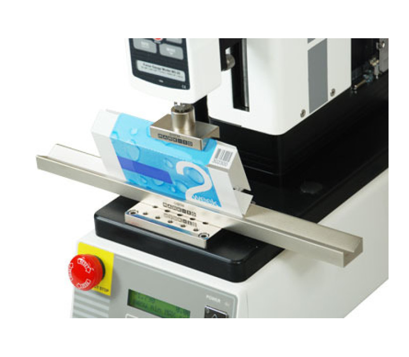 G1072 is shown testing a card board packaging, mounted to a motorized test stand with force gauge.