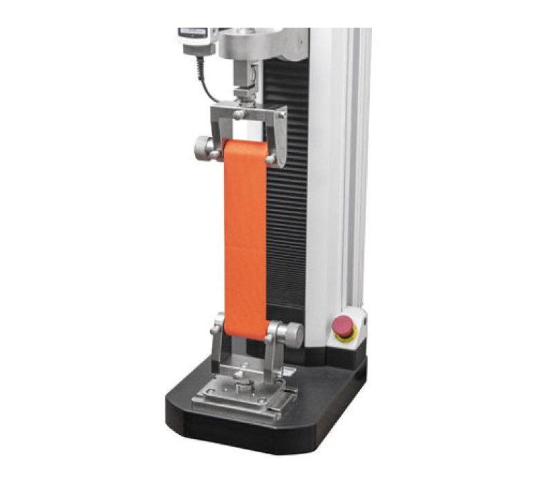 A pair of G1111 ribbon grips are shown in a typical application, with force test stand and load cell.
