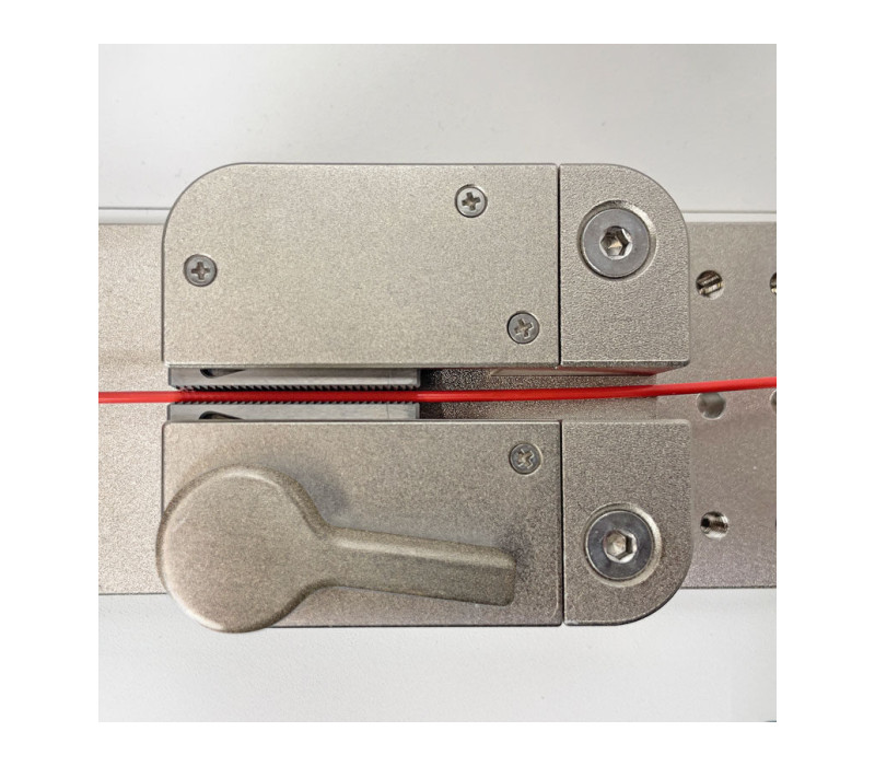 Wedge grip secures the sample between serrated jaws.